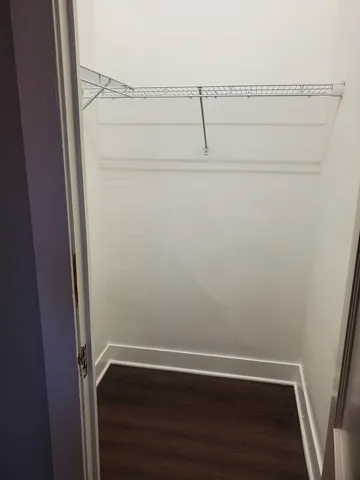 a view of small space with racks on the wall and a window