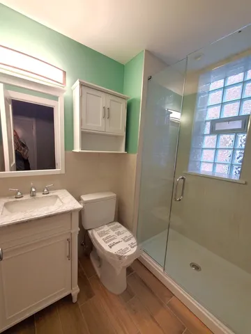 a bathroom with a toilet sink and shower