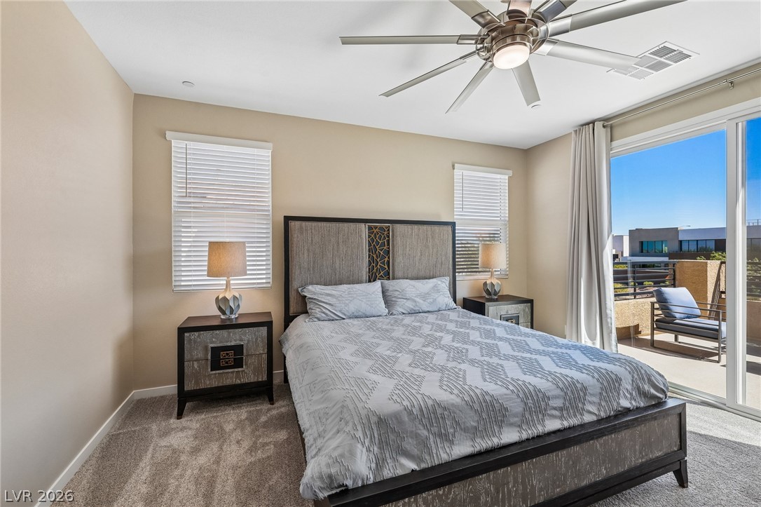 194 Viento Ridge Street Henderson, NV 89012 - Photo 29 of 72 Sliding glass doors open from this carpeted bedroom directly onto a private balcony.