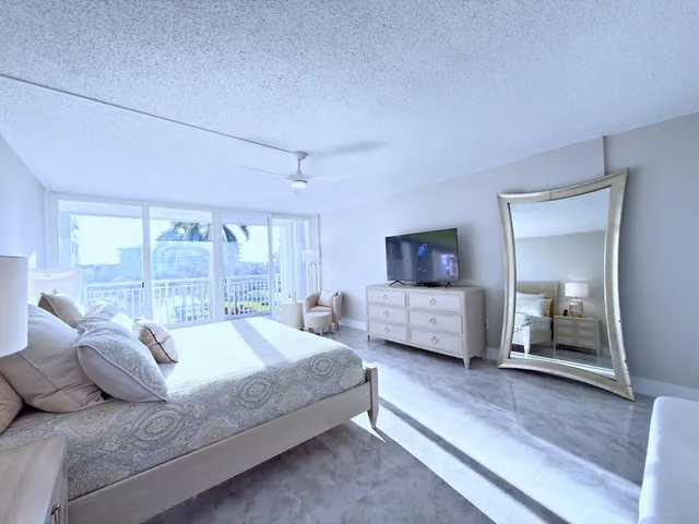 a bathroom with a sink vanity granite toilet and shower