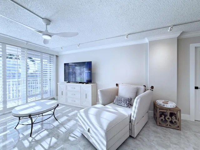 a bedroom with furniture and a flat screen tv