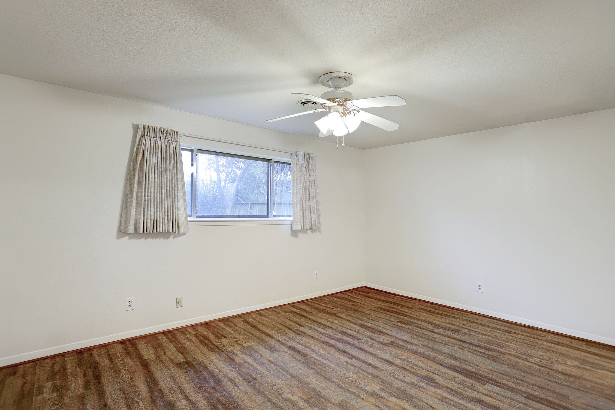 7739 Kensico Road Houston, TX 77036 - Photo 9 of 21 wooden floor in an empty room with a window
