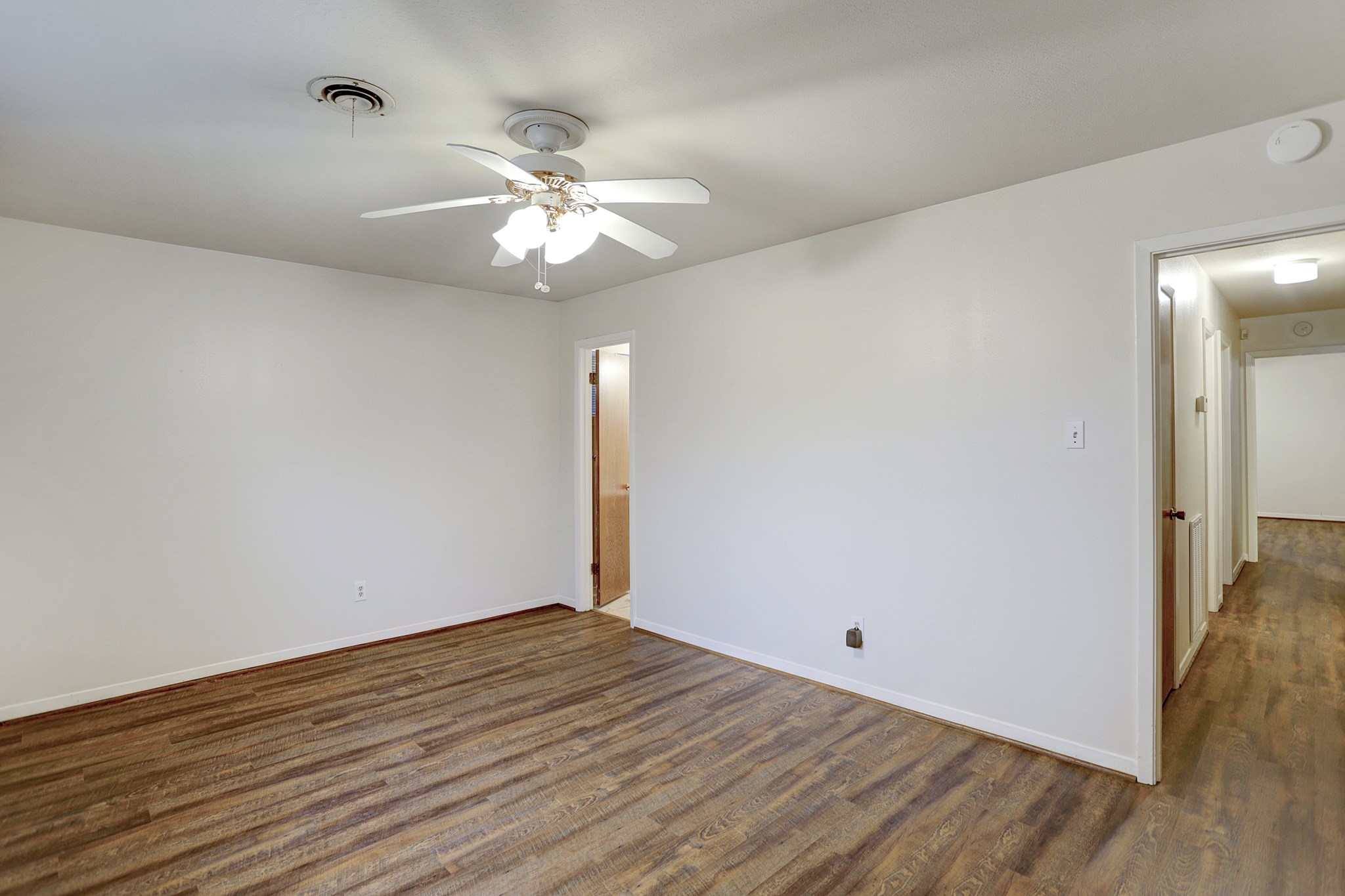 7739 Kensico Road Houston, TX 77036 - Photo 10 of 21 a view of an empty room with wooden floor