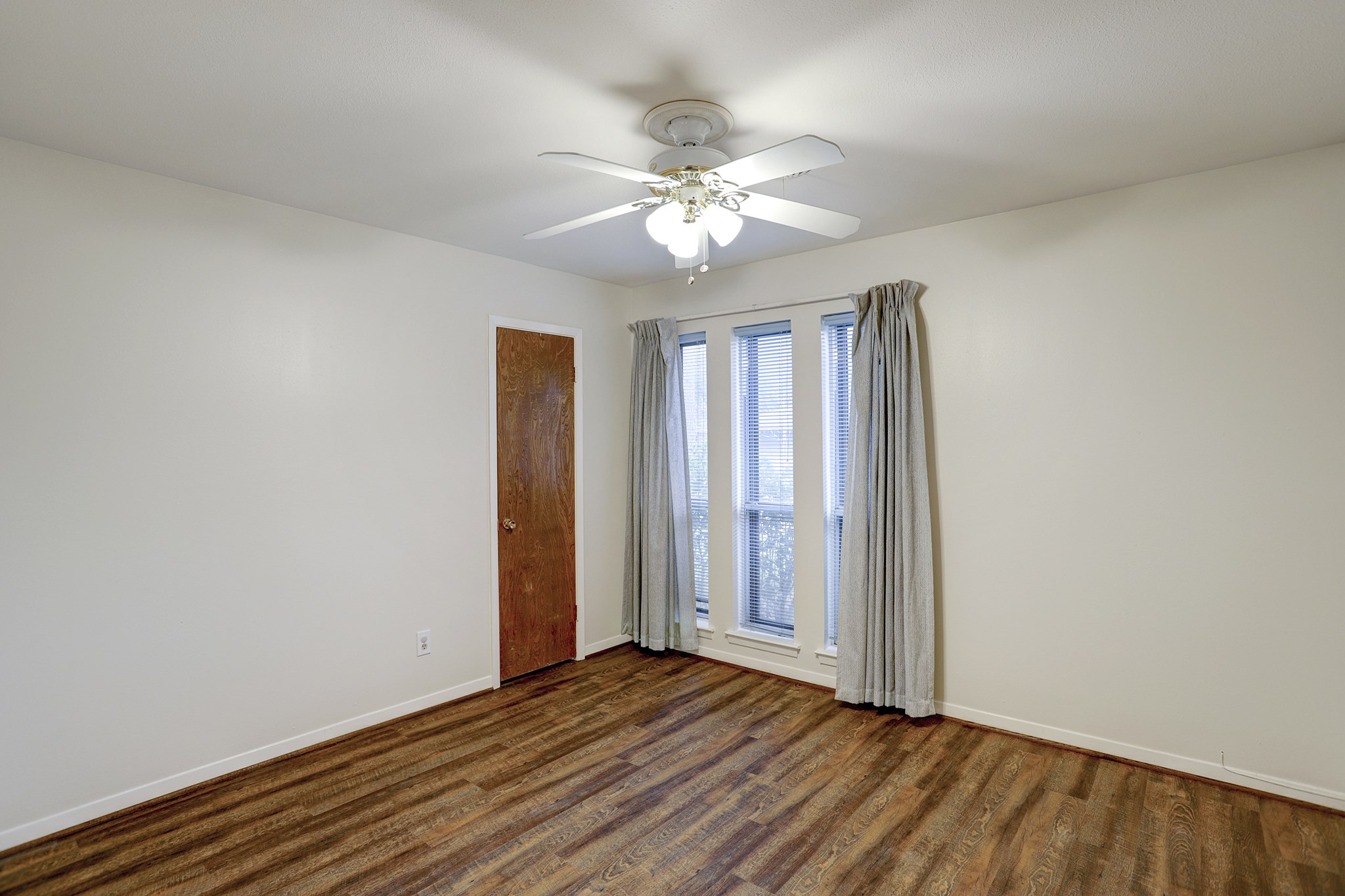 7739 Kensico Road Houston, TX 77036 - Photo 12 of 21 a view of an empty room with wooden floor