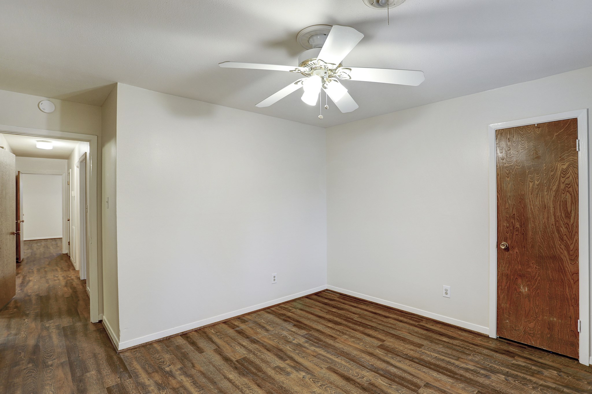 7739 Kensico Road Houston, TX 77036 - Photo 13 of 21 an empty room with wooden floor fan and windows