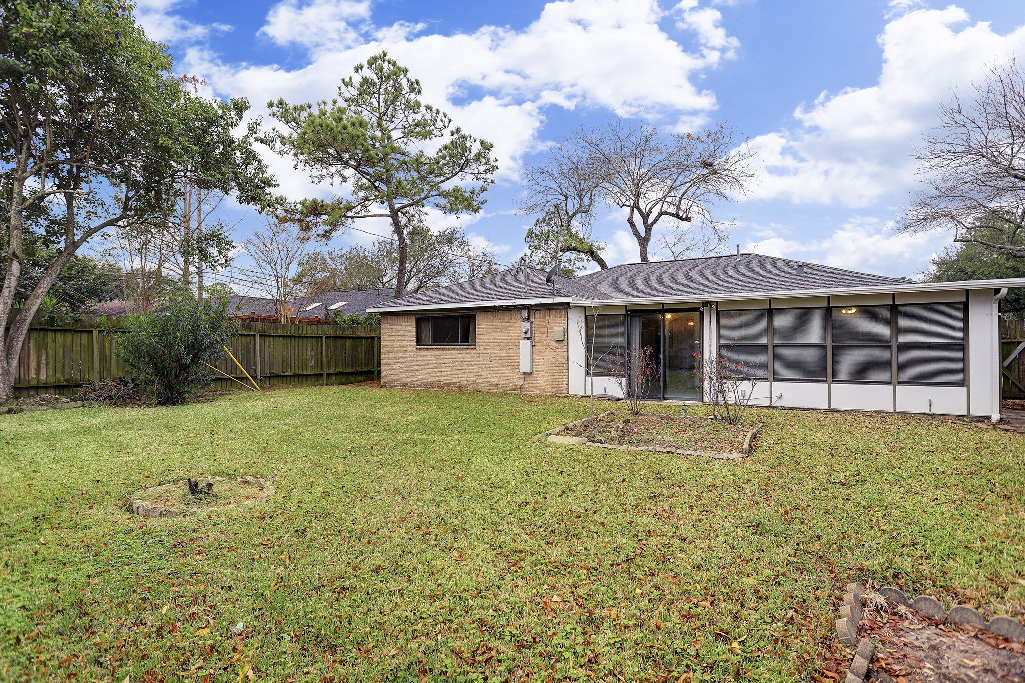 7739 Kensico Road Houston, TX 77036 - Photo 17 of 21 a front view of a house with a garden and yard