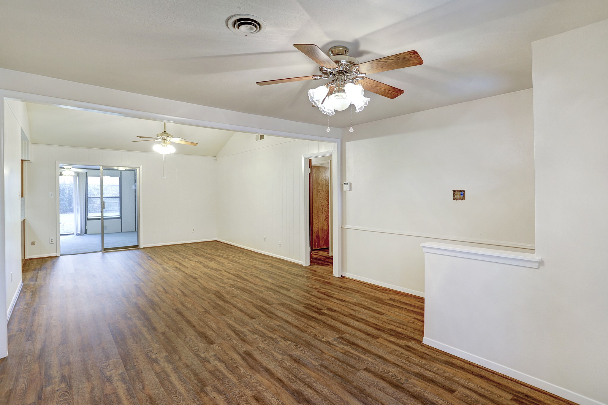 7739 Kensico Road Houston, TX 77036 - Photo 2 of 21 a view of empty room with wooden floor
