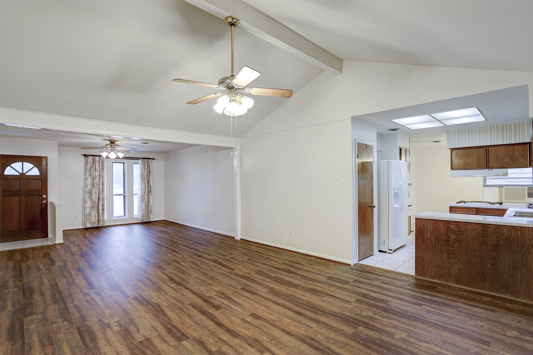 7739 Kensico Road Houston, TX 77036 - Photo 3 of 21 a view of an empty room with window and wooden floor