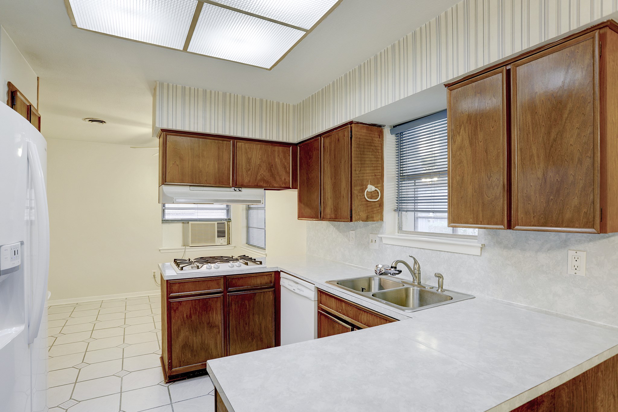 7739 Kensico Road Houston, TX 77036 - Photo 5 of 21 a kitchen with stainless steel appliances granite countertop a sink stove and refrigerator