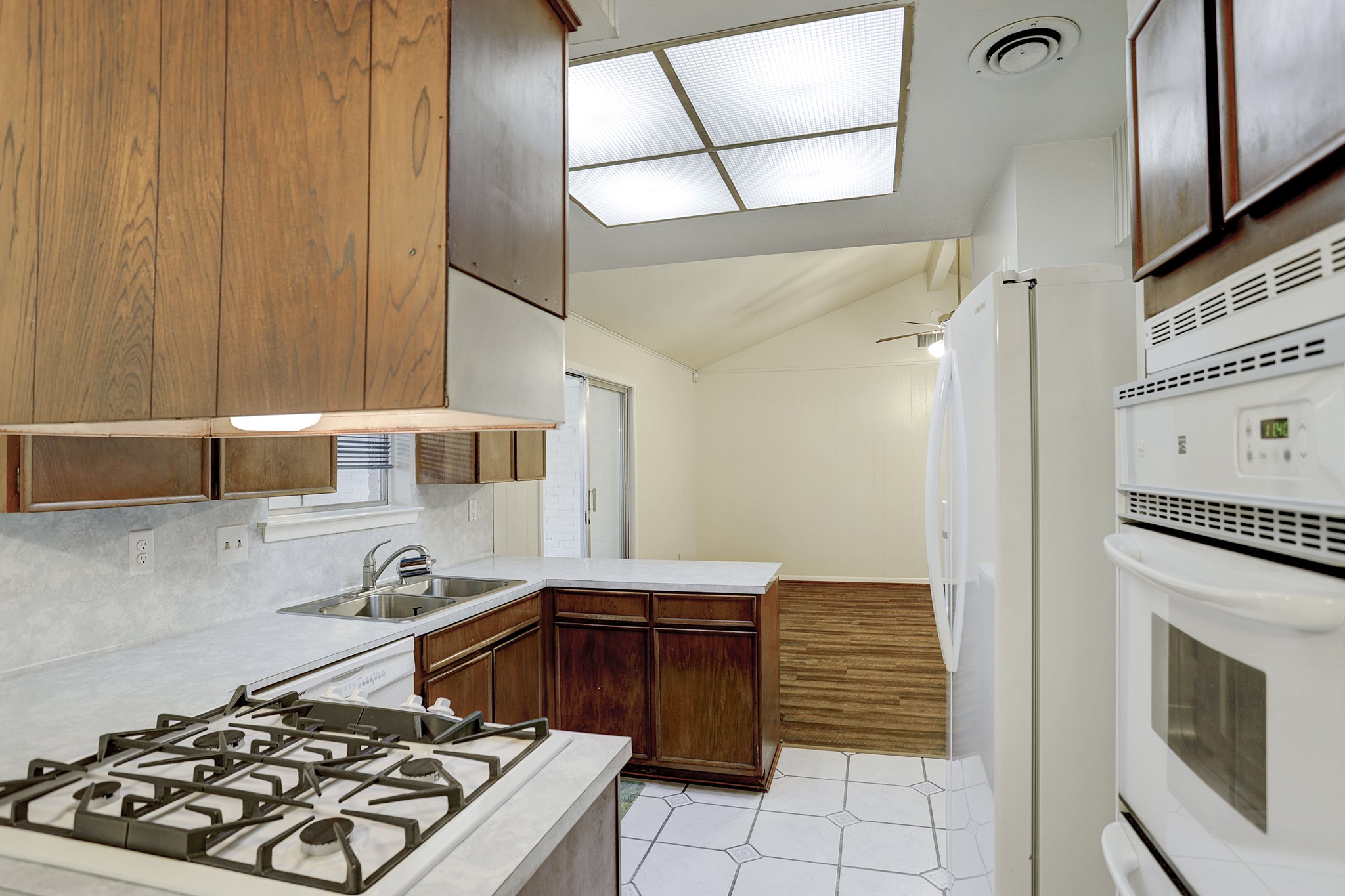 7739 Kensico Road Houston, TX 77036 - Photo 6 of 21 a kitchen with stainless steel appliances granite countertop a stove and a refrigerator