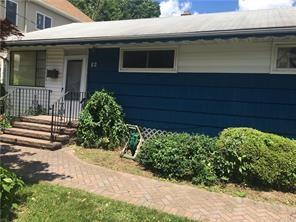 a view of a house with a yard and potted plants