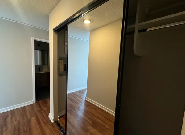 a view of a hallway with wooden floor