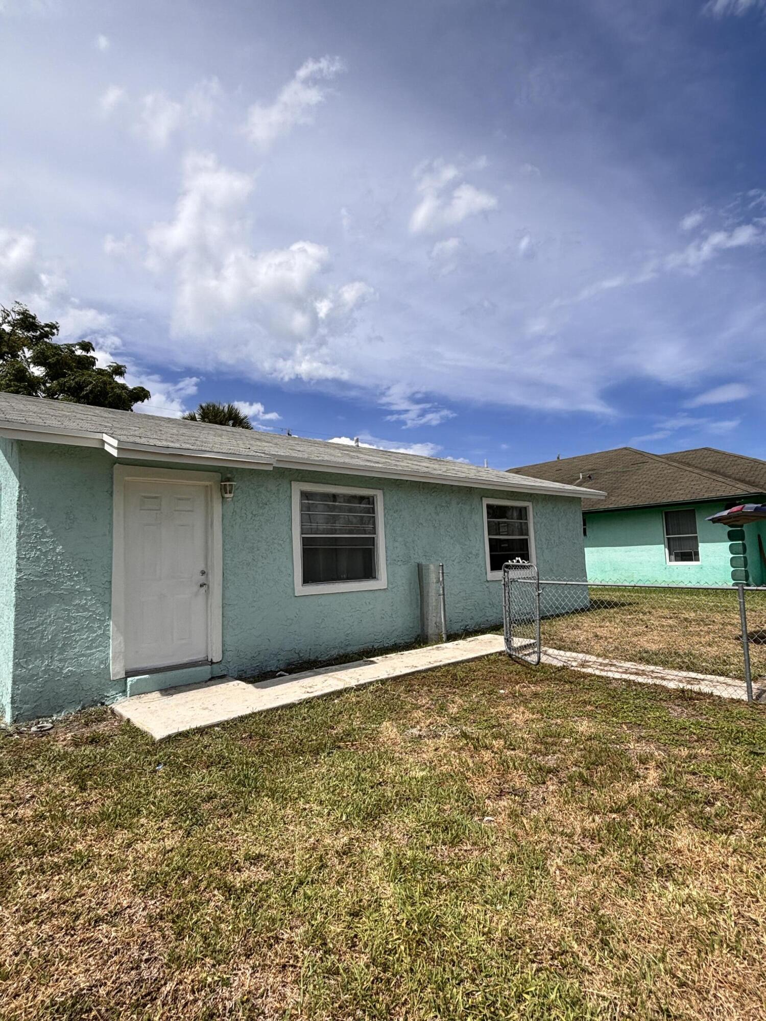 1328 West 6th Street Riviera Beach, FL 33404 - Photo 3 of 11 a view of a house with a yard