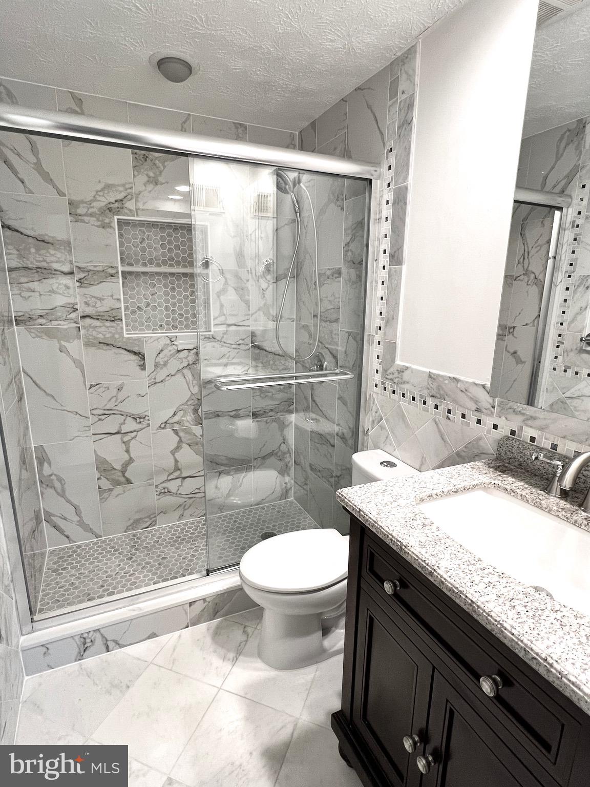 9624 Glendower Court Laurel, MD 20723 - Photo 19 of 26 a bathroom with a granite countertop sink toilet and shower