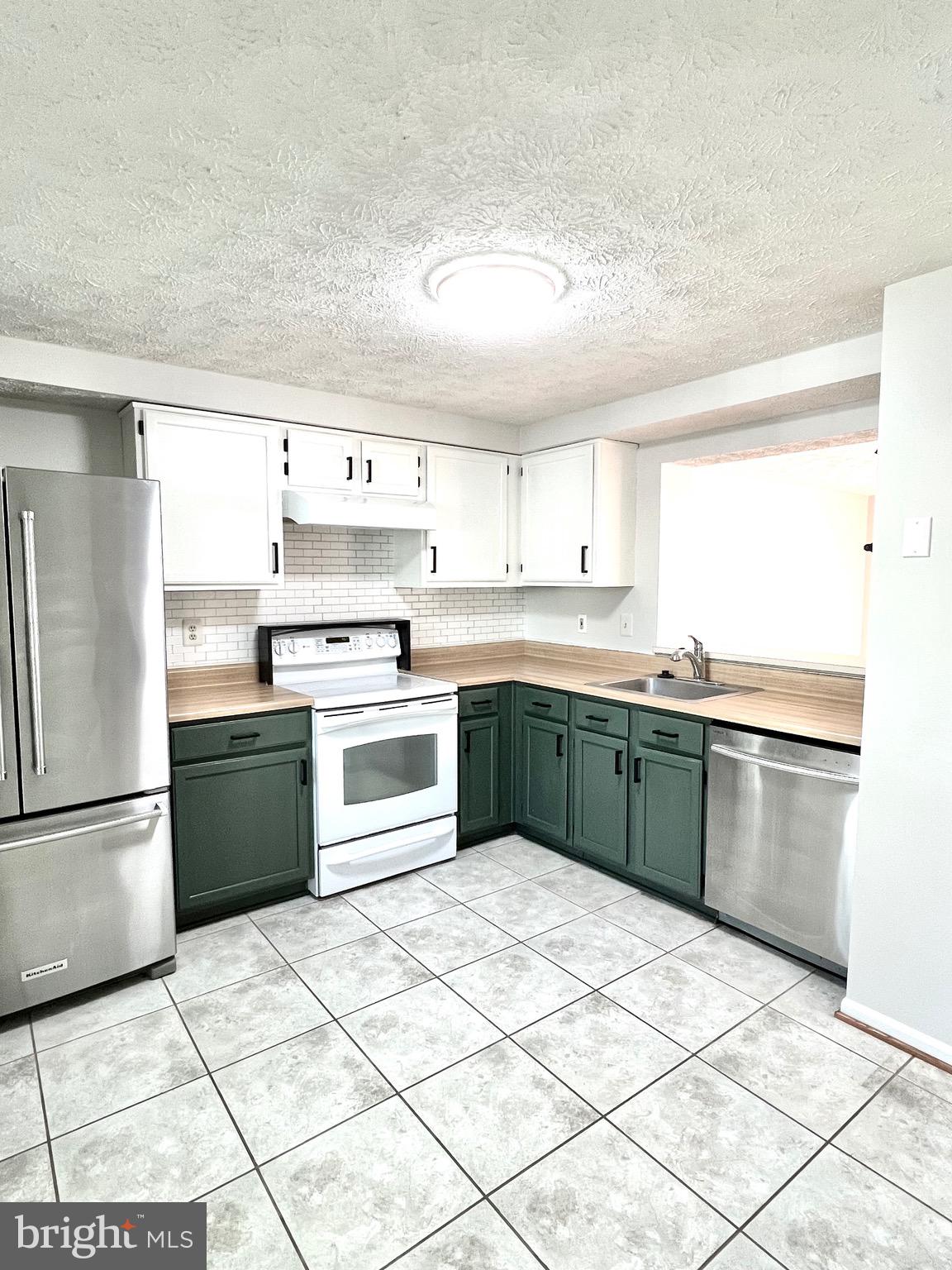 9624 Glendower Court Laurel, MD 20723 - Photo 6 of 26 a kitchen with a cabinets and white stainless steel appliances