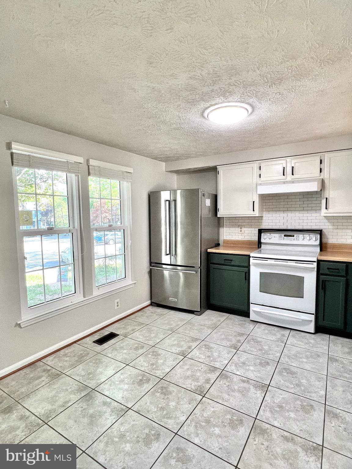 9624 Glendower Court Laurel, MD 20723 - Photo 7 of 26 a kitchen with stainless steel appliances granite countertop a stove a sink and a refrigerator