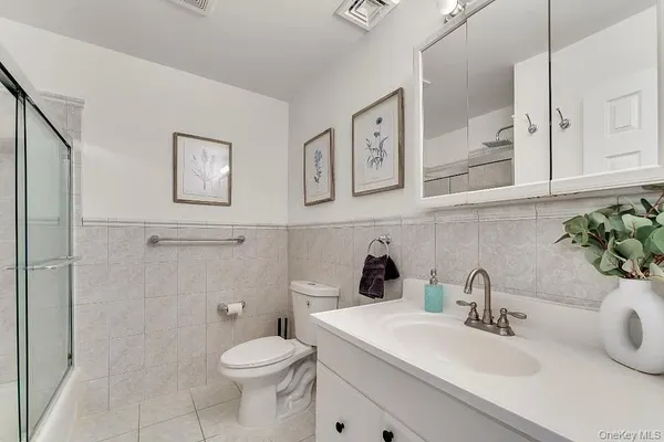 a view of entryway bedroom and hall with wooden floor