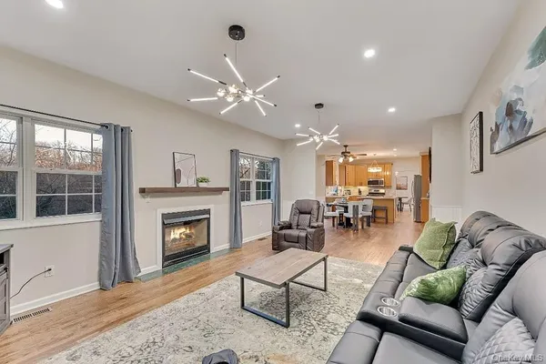 a living room with furniture fireplace and window
