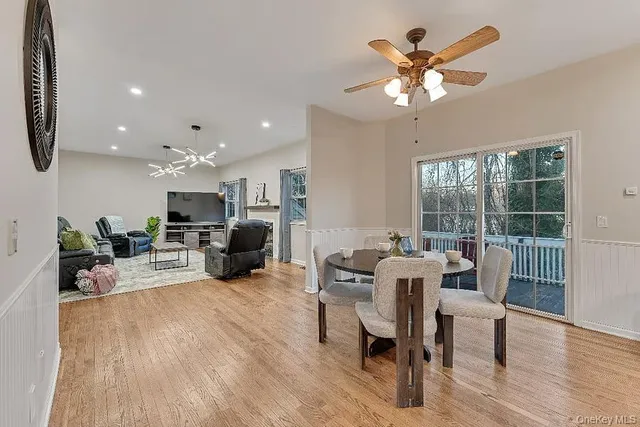 a living room with furniture a fireplace and a chandelier