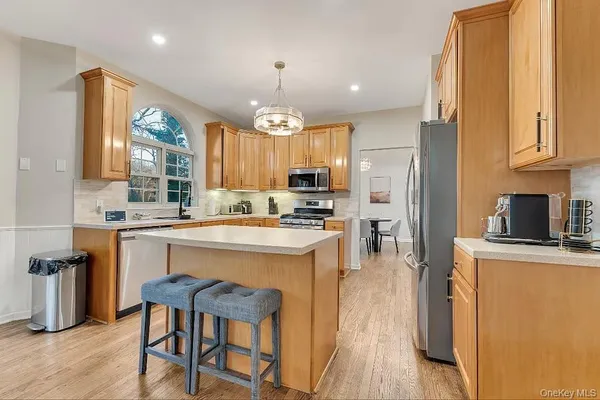 a kitchen with stainless steel appliances granite countertop a stove refrigerator sink and cabinets