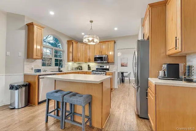 a kitchen with stainless steel appliances granite countertop a stove refrigerator sink and cabinets