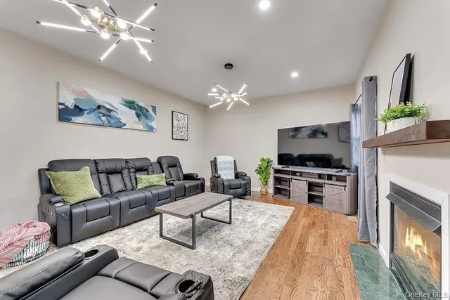 a living room with furniture a fireplace and a flat screen tv