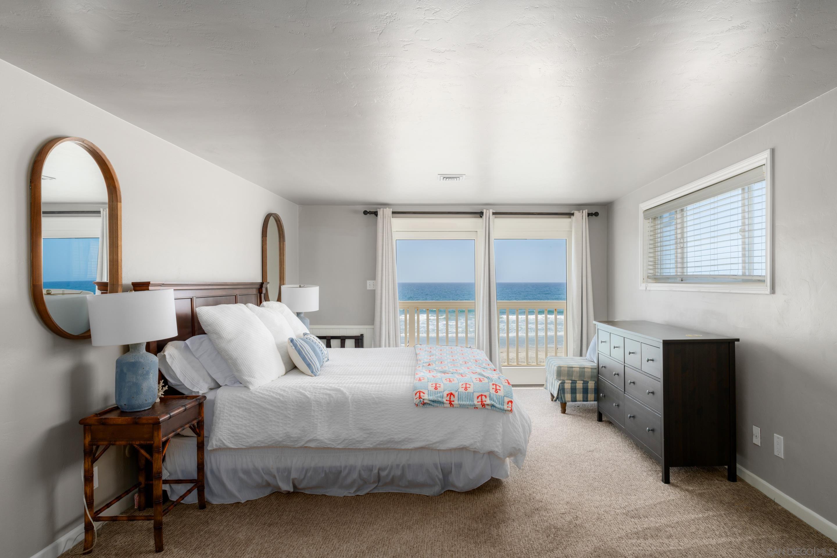 1834 Ocean Front Del Mar, CA 92014 - Photo 13 of 36 a bedroom with bed and a large window
