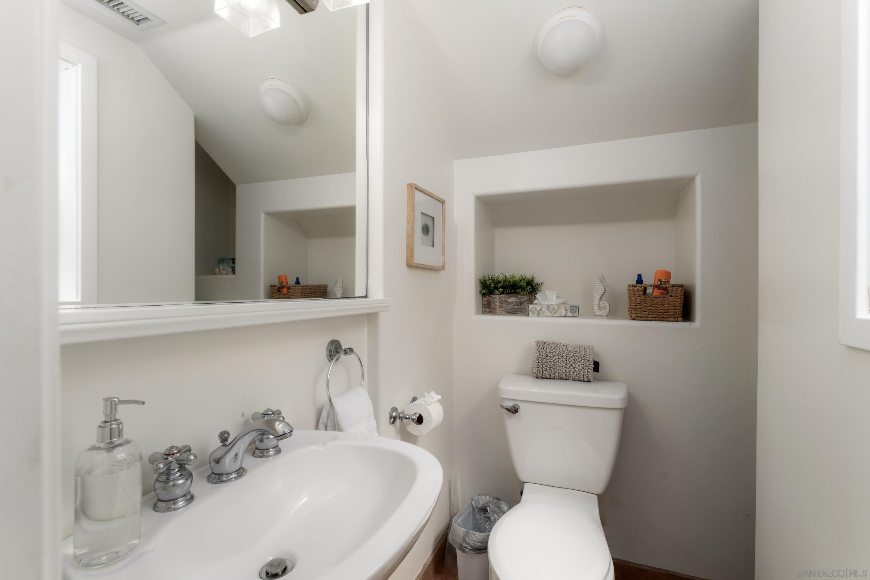 1834 Ocean Front Del Mar, CA 92014 - Photo 16 of 36 a bathroom with a toilet sink and mirror