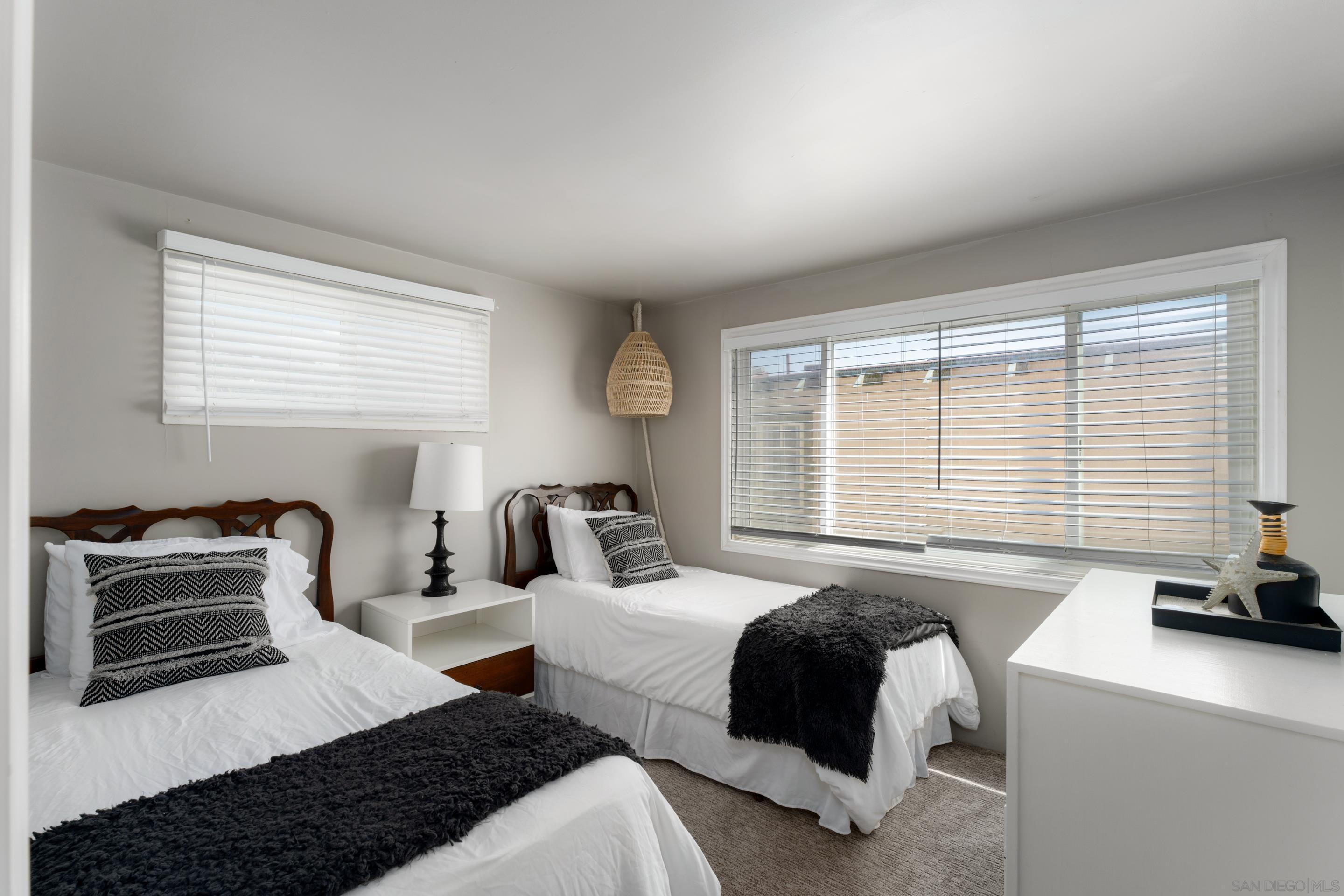 1834 Ocean Front Del Mar, CA 92014 - Photo 18 of 36 a bedroom with two beds and a large window