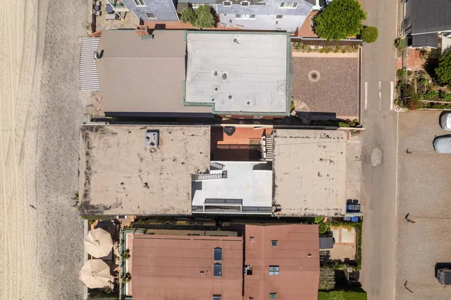 an aerial view of a kitchen with granite countertop white cabinets and a sink