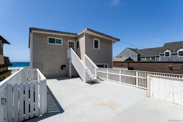 a view of a house with wooden fence