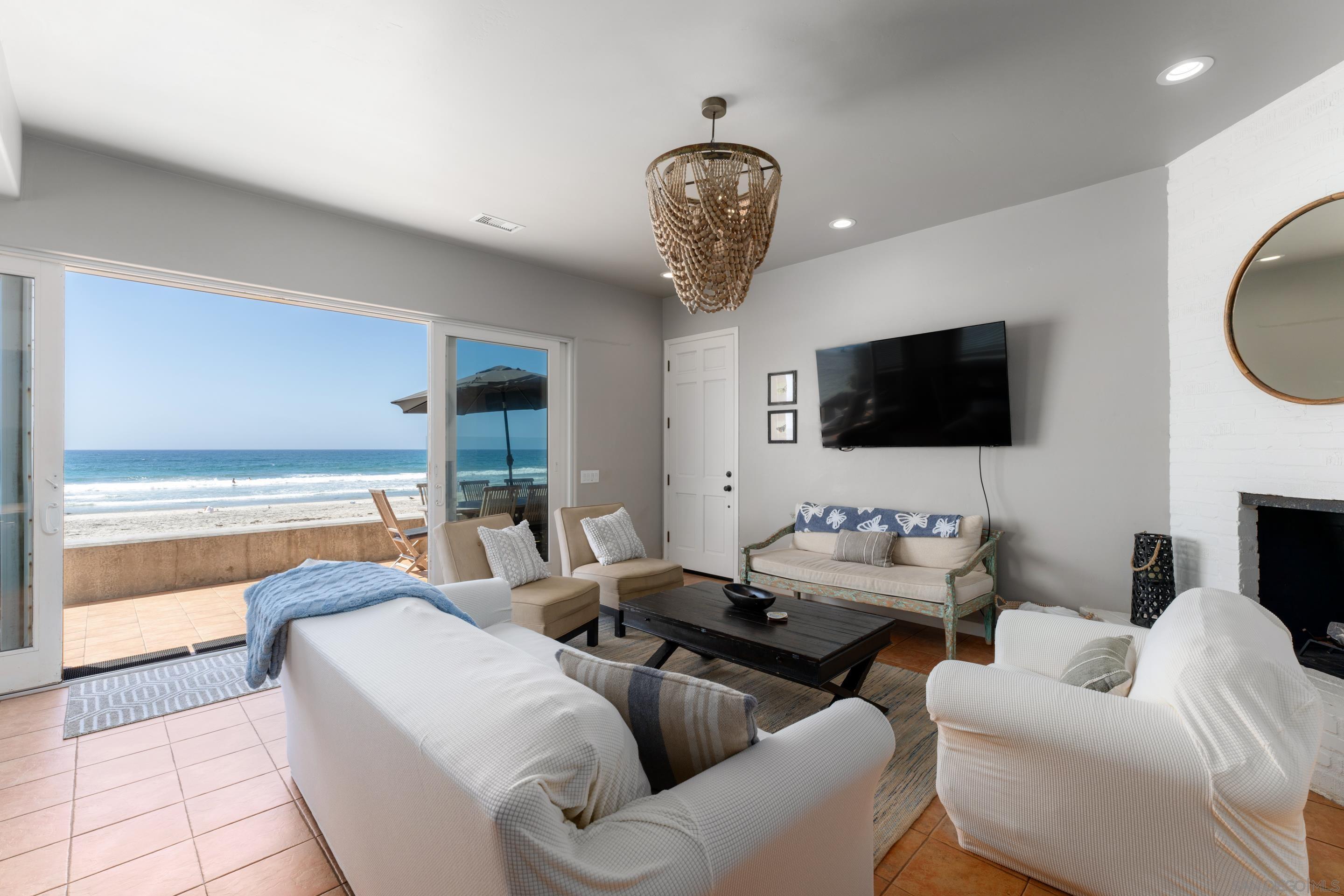 1834 Ocean Front Del Mar, CA 92014 - Photo 7 of 36 a living room with furniture and a flat screen tv