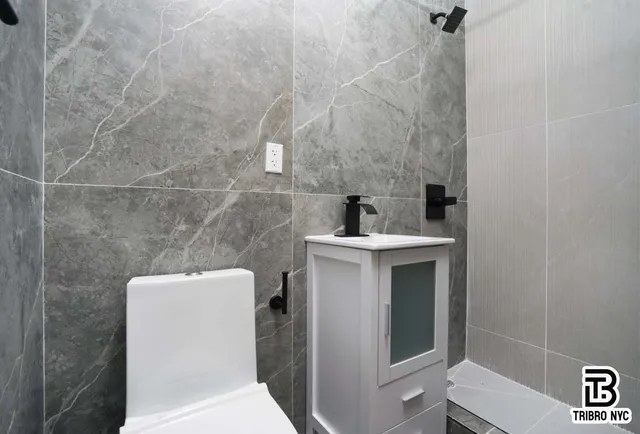 a bathroom with a toilet sink and shower