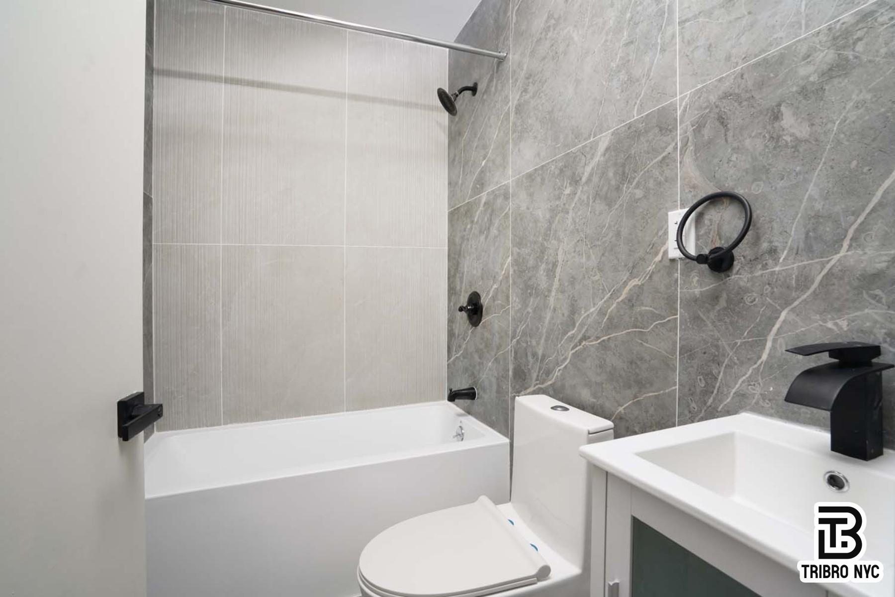 1731 Norman Street, Unit 1R Queens, NY 11385 - Photo 8 of 10 a bathroom with a sink a toilet and a bathtub