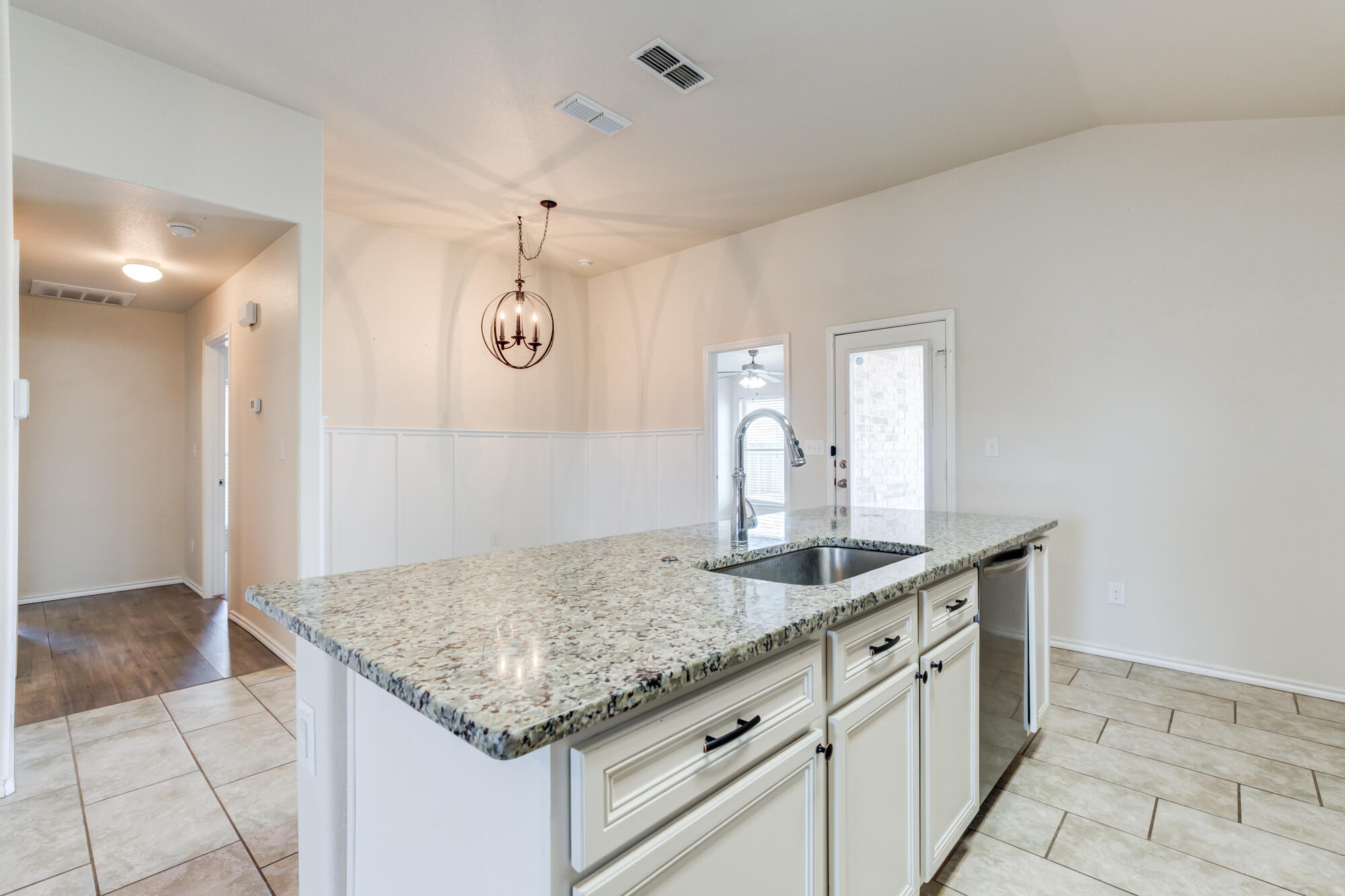 7012 34th Place Lubbock, TX 79407 - Photo 16 of 36 a bathroom with a granite countertop sink and a mirror