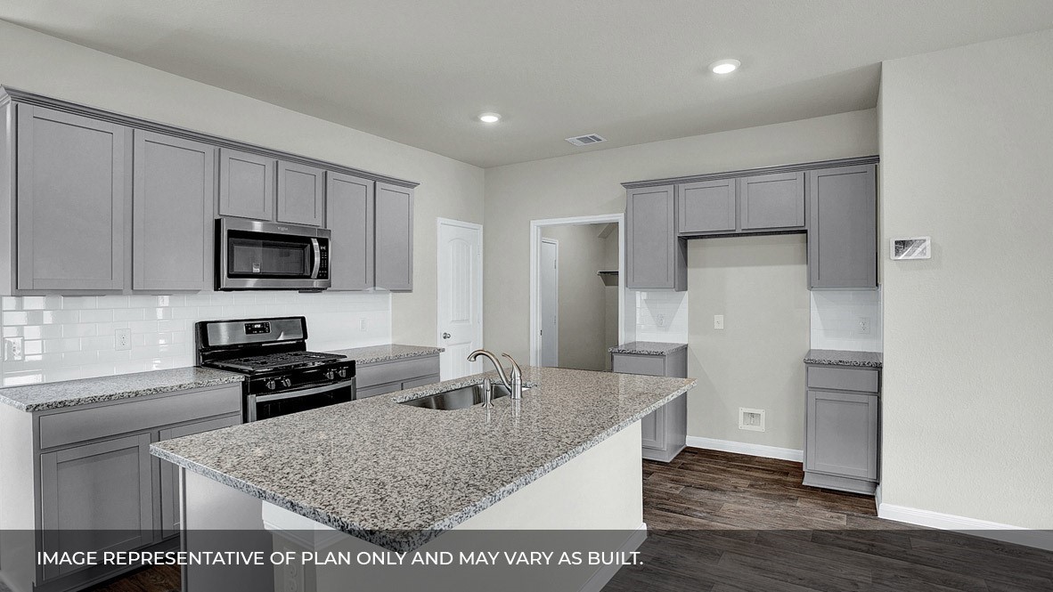 407 Robin Court Angleton, TX 77515 - Photo 5 of 22 a kitchen with granite countertop a refrigerator and a stove top oven