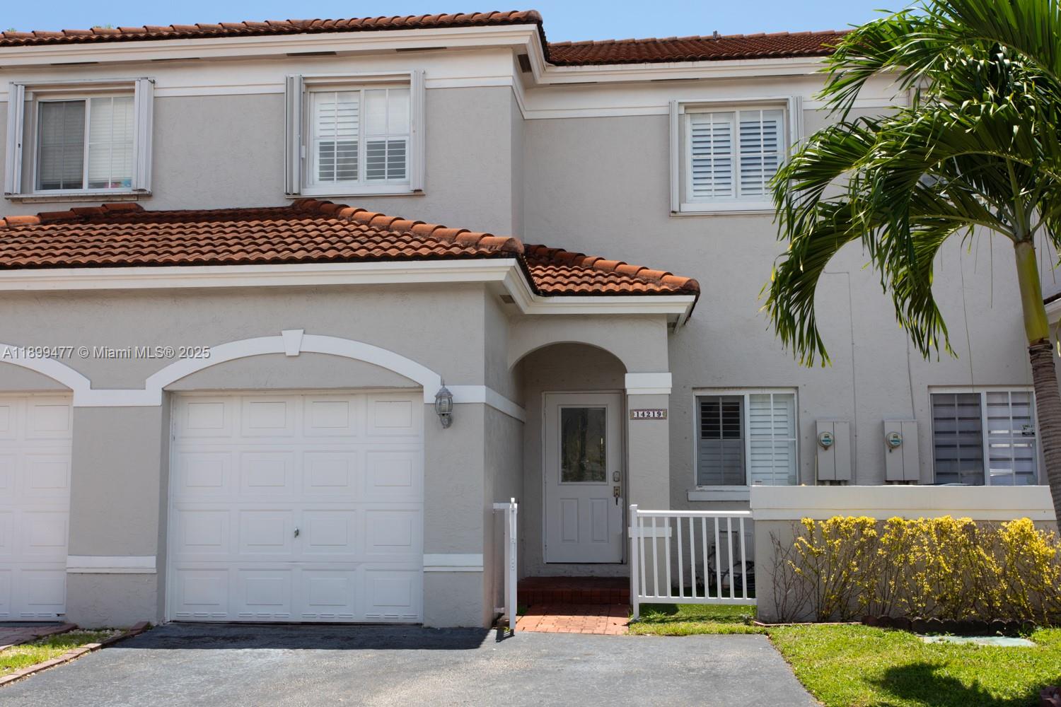 a view of front door and potted plants