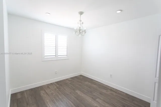 an empty room with walk in closet and window