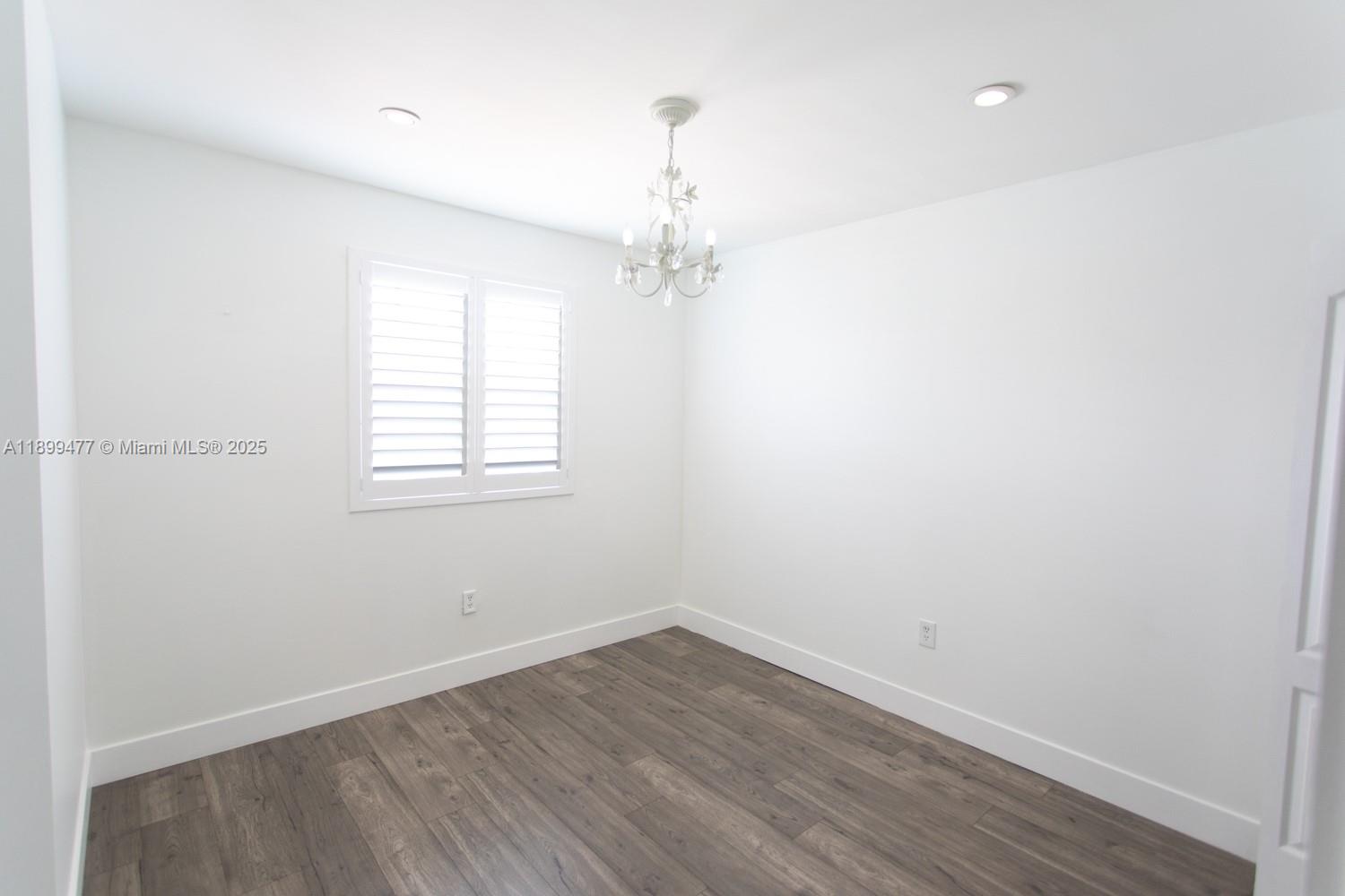 14219 Southwest 126th Place Miami, FL 33186 - Photo 16 of 26 wooden floor in an empty room with a window