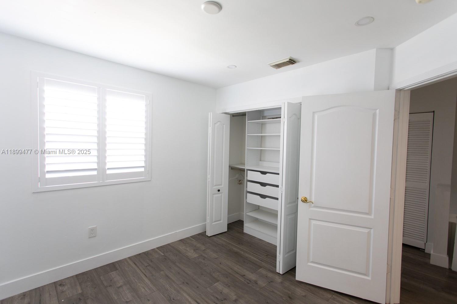 14219 Southwest 126th Place Miami, FL 33186 - Photo 18 of 26 an empty room with walk in closet and window