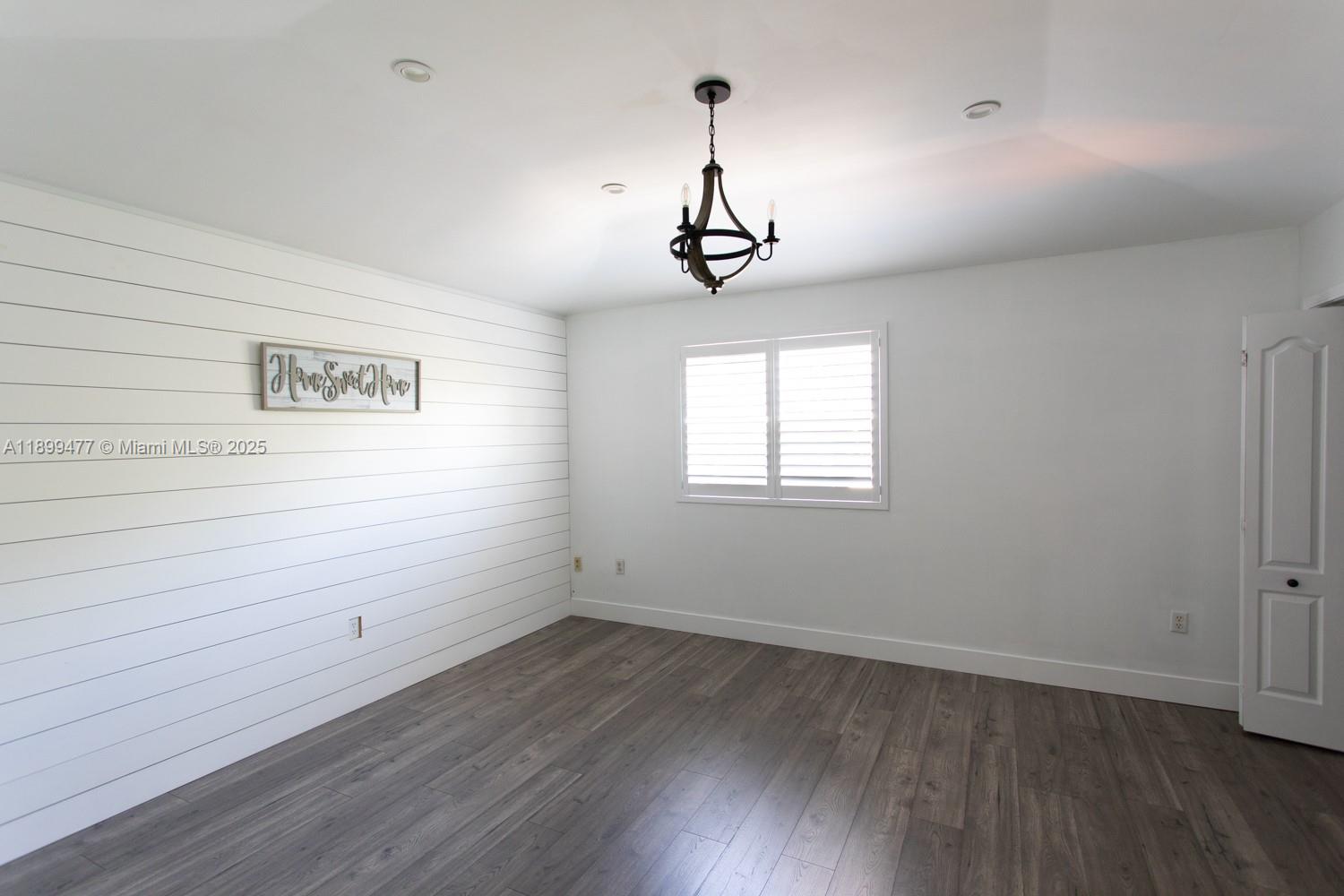 14219 Southwest 126th Place Miami, FL 33186 - Photo 20 of 26 a view of a room with wooden floors and ceiling fan