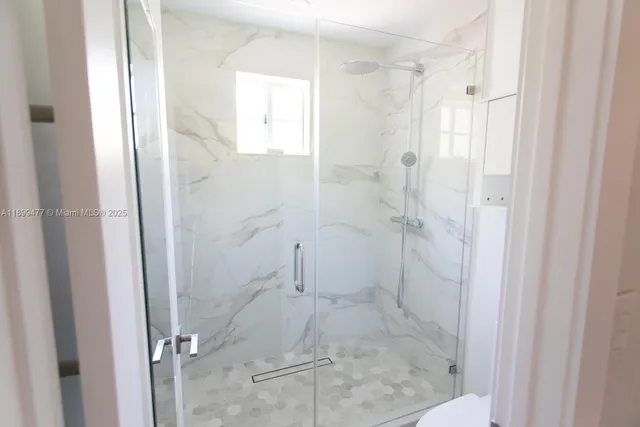 a view of a yard with plants and a large tree