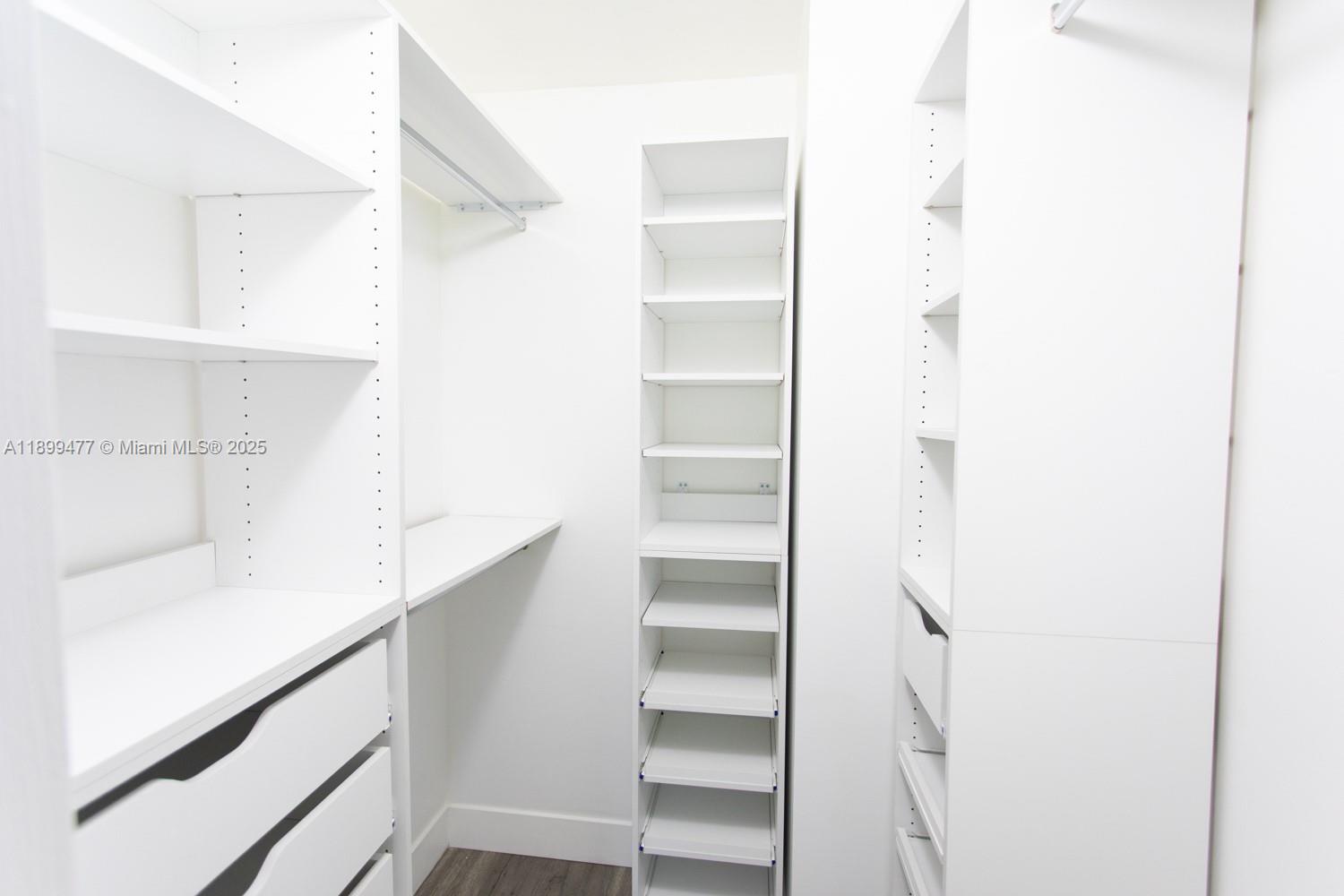 14219 Southwest 126th Place Miami, FL 33186 - Photo 24 of 26 a view of walk in closet with empty racks