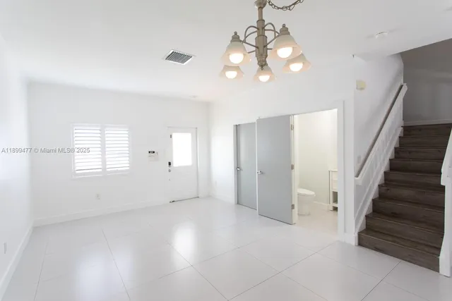 a view of a kitchen with a refrigerator and a stove