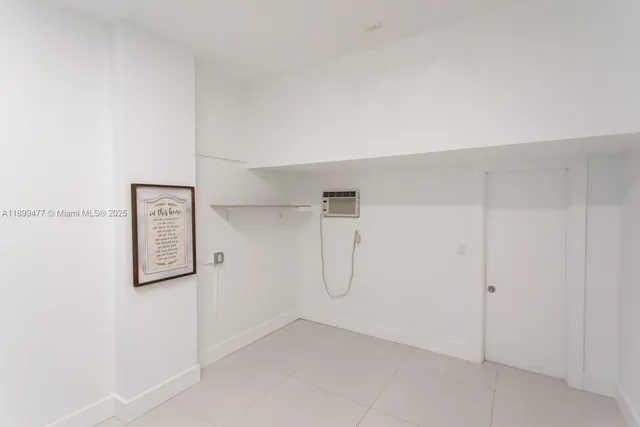 a kitchen with stainless steel appliances kitchen island a refrigerator sink and cabinets