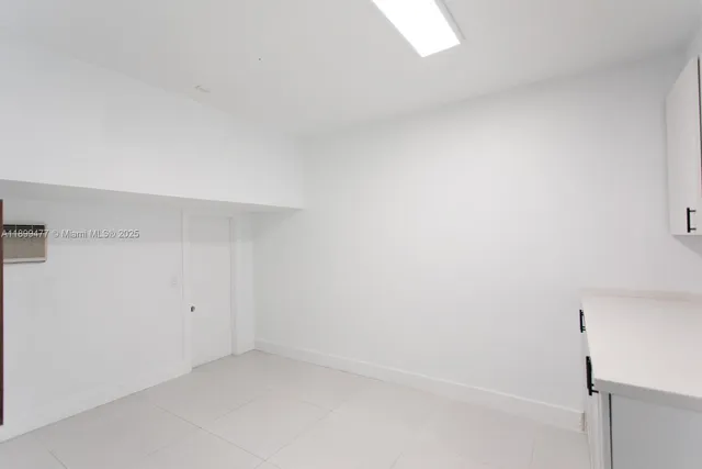 a kitchen with granite countertop a sink and a refrigerator