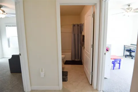a bedroom with a bed and dresser with mirror