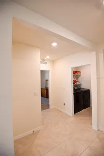 a large white kitchen with stainless steel appliances
