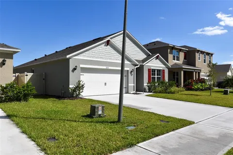 a view of a pathway of a house with backyard
