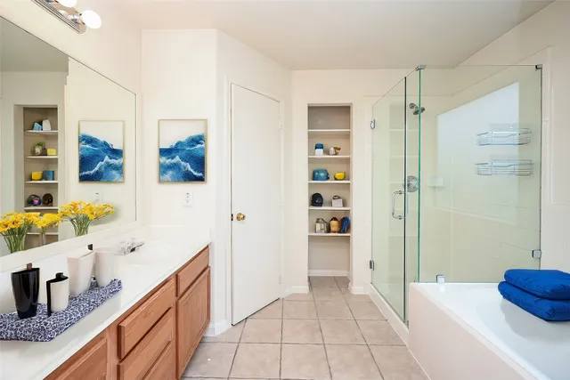 a bathroom with a tub sink and shower